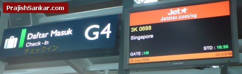 Checking in luggage and getting boarding pass at JetStar counter Checking in luggage and getting boarding pass at JetStar counter