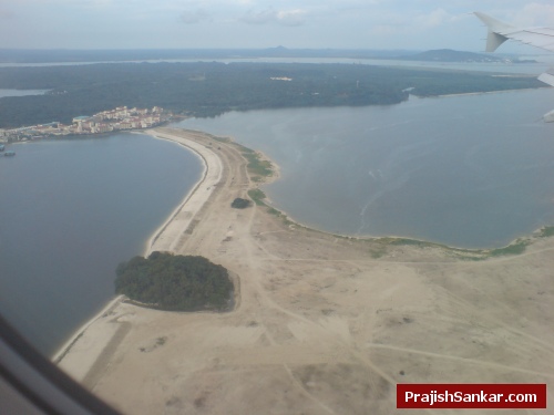 A few seconds before landing. A small green island is joined using reclaimed land A few seconds before landing. A green island is joined using reclaimed land
